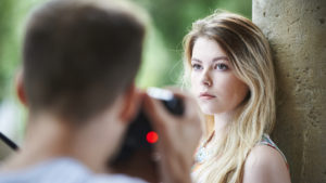 Portrait of a photographer taking pictures of a model outdoors, taken on September 4, 2015. (Photo by Joseph Branston/Digital Camera Magazine)